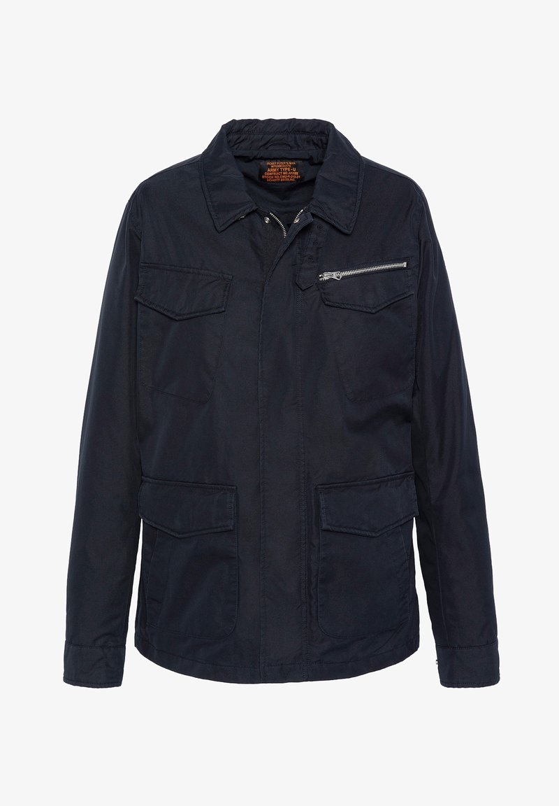 Marineblaue Jacke mit einer Reißverschlusstasche auf der Brust, zwei vorderen Klappentaschen und einem Kragen. Hergestellt aus strapazierfähigem Material mit matter Oberfläche.