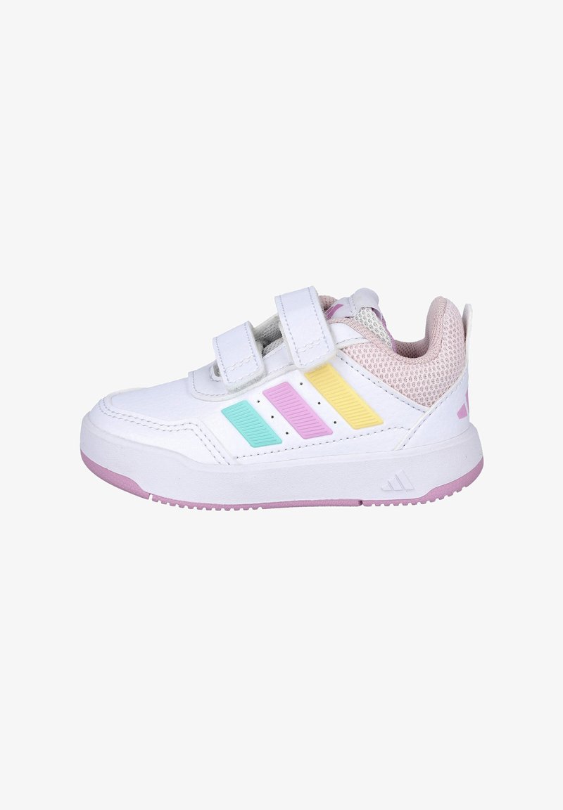 Zapatilla deportiva blanca con tiras de velcro, con rayas en tonos pastel azul, rosa y amarillo, acentos de malla texturizada y una suela de goma rosa.