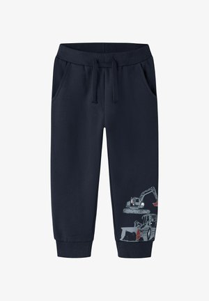 Marineblaue Sweatpants aus Baumwollmischung mit elastischem Bund, seitlichen Taschen und einem Aufdruck von Baumaschinen am linken Bein.