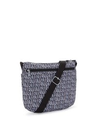Borsa a tracolla in tessuto stampato bianco e nero, con un scomparto con zip e una tracolla nera regolabile.