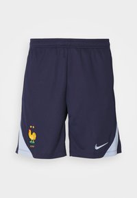 Marineblauwe sportshorts gemaakt van ademend materiaal, met een gele haanlogo en lichtblauwe accenten aan de zijkanten. Inclusief Nike-branding.