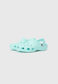 Light blue clogs featuring a closed toe and open heel design with ventilation holes and a raised band pattern across the top.