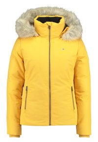Geel gewatteerde jas met een bontomrand capuchon, ritssluiting aan de voorkant, zijzakken, geribbelde manchetten en een klein logo op de borst.
