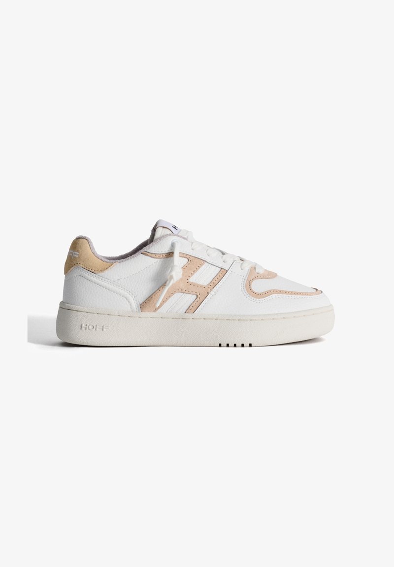 White leather sneakers with beige suede accents, rounded toe, thick white sole, and logo detail on the heel and tongue.