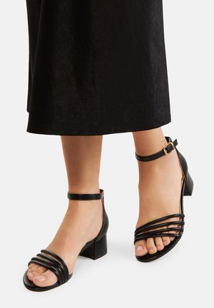 Sandale negre din piele cu toc bloc, dotate cu trei curele orizontale și o curea ajustabilă la gleznă. Textură netedă, design cu vârf deschis.