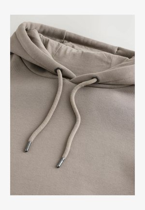 Hanorac bej cu textură moale, prevăzut cu glugă cu șnur și capete metalice, cu croială lejeră, realizat dintr-un amestec de bumbac.