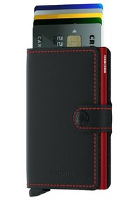Black leather wallet with red stitching, featuring a card slot displaying several credit cards and a button closure. Brand logo visible.