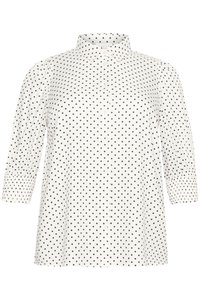 Chemise blanche à boutons avec des pois noirs, manches trois-quarts, col pointu et texture de tissu lisse.