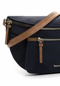 Navy fabric crossbody bag with gold zippers, brown leather accents, and an adjustable strap. Features a main compartment and external pocket.