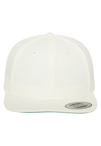 White snapback cap with textured fabric, curved brim, and six ventilation holes. Features a round, branded tag on the left side.