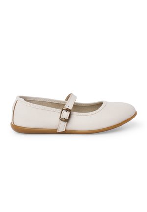 White Mary Jane flat shoe with brown buckle strap and light brown sole, shown in side profile on a white background.
