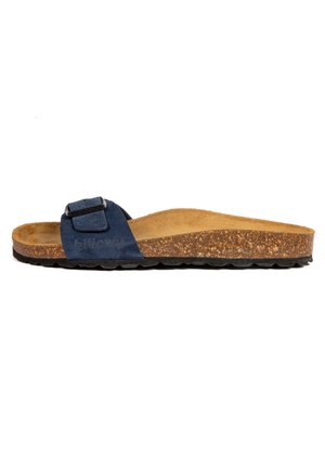 Sandale à glissière en suède bleu marine avec une semelle en liège et une semelle en caoutchouc noir texturé. Comprend une seule sangle ajustable avec une boucle.