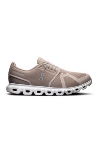 Light beige running shoe with mesh upper, white sole, and reinforced heel. Features lace closure and curved design for flexibility.