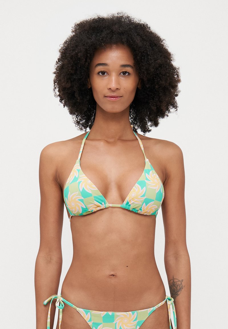 Bikini set in green with floral pattern, featuring a triangular top and ties on the sides. Material is smooth and stretchy.