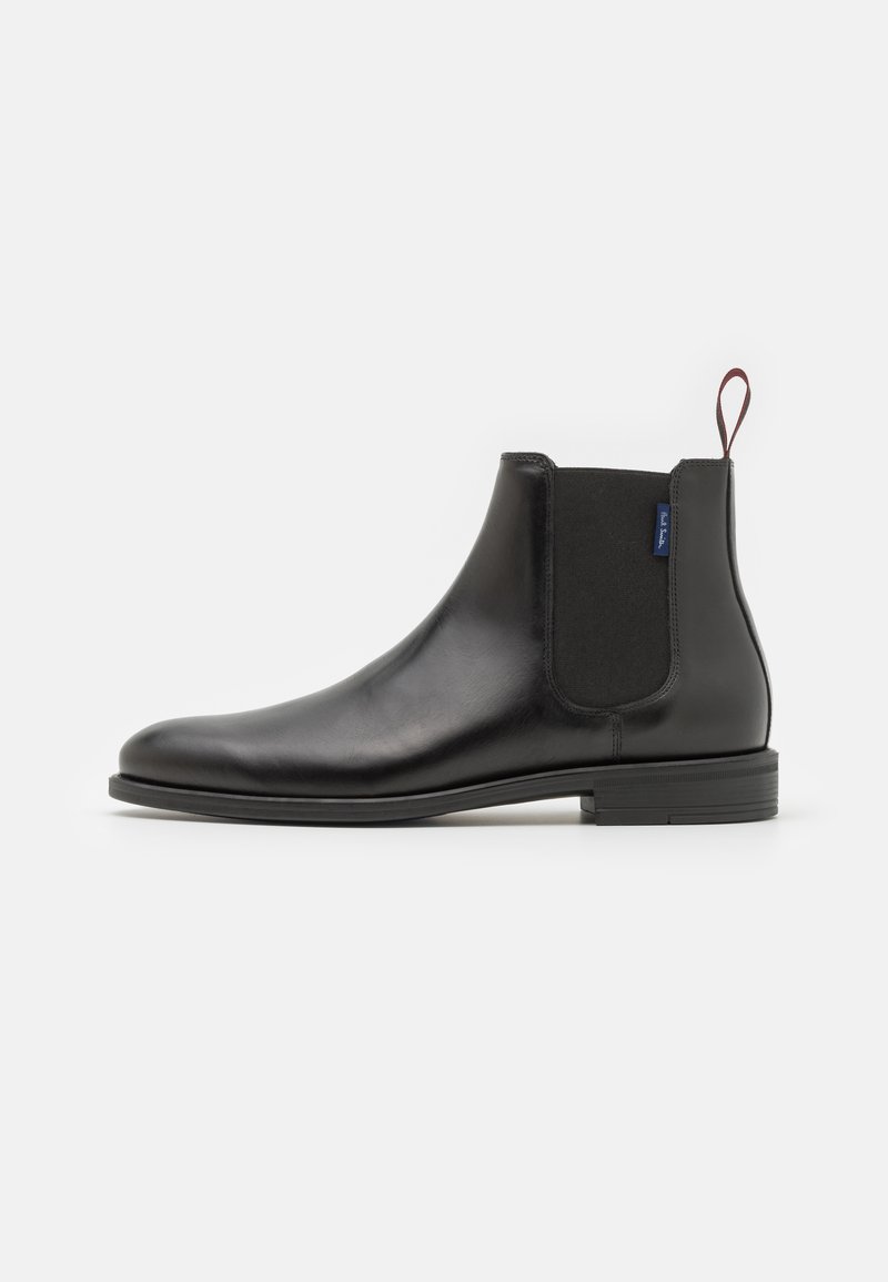 Black leather Chelsea boot with elastic side panels, rounded toe, pull tab at the heel, and a flat rubber sole.