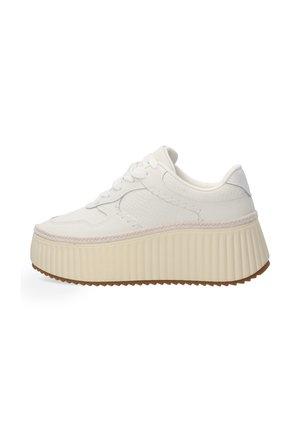 White platform sneakers with a textured upper, flat laces, and a thick, ribbed cream sole. Features subtle stitching and a smooth finish.