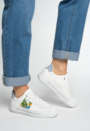White sneakers with a patterned side panel, light blue heel, and textured rubber sole, paired with rolled-up denim jeans.