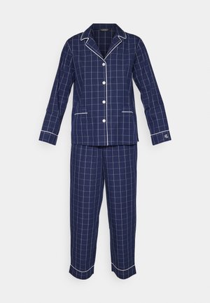 Pajama set u tamnoplavu kariranu boju s bijelim mrežastim uzorkom, koji se sastoji od košulje s dugmadi i odgovarajućih hlača. Mekani materijal s kontrastnim obrubom.