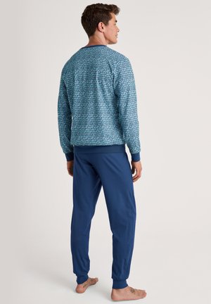 Blauwe geprinte lange mouwen top met ribbelboorden, gecombineerd met blauwe joggingbroeken met elastische enkels. Casual lounge set, zachte stof.