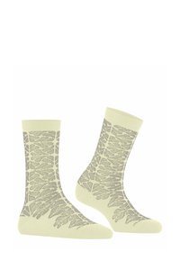 Kremowe skarpetki z szarymi wzorami liści paproci, sięgającymi od kostki do palców, przedstawione obok siebie na białym tle.