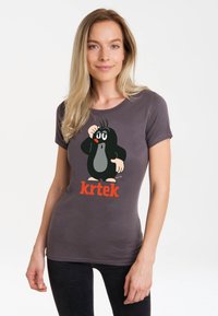 Gray fitted t-shirt featuring a printed cartoon mole character with a prominent black and gray design and "krtek" text in bold orange.