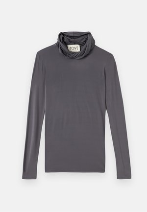 Harmaa pitkähihainen kaula-aukko paita yhdistettynä mustaan, vartalonmyötäiseen maxi-hameeseen; sileä kangas, jossa on tyylikäs siluetti.