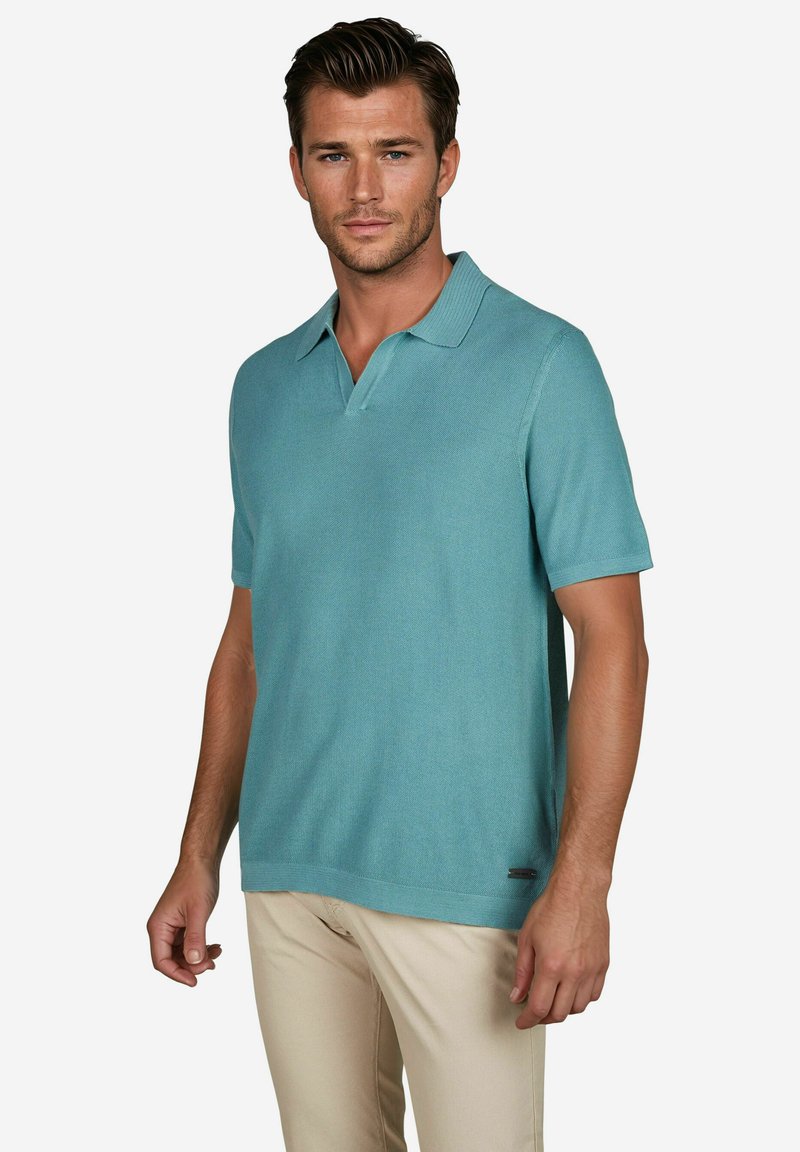Korte mouwen polo shirt in licht teal, gemaakt van gestructureerde stof, met een kraag en een klein logo accent vlak bij de zoom.