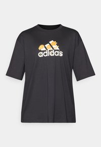 Black oversized t-shirt made of cotton, featuring a floral graphic and the Adidas logo in white and yellow across the chest.