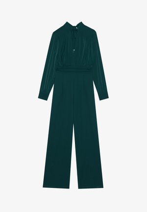 Mørkegrøn jumpsuit med lange ærmer, dyb V-hals, samlede detaljer ved taljen og brede bukser. Glat, struktureret stof.
