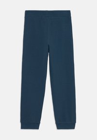 Navy blue ribbed leggings with a wide elastic waistband and fitted cuffs at the ankles. Made of soft, stretchy material for comfort.