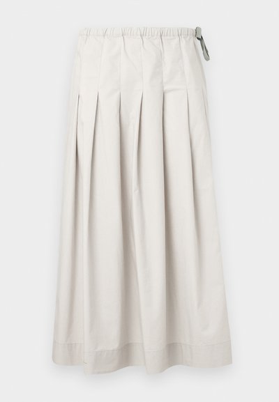 Φούστα μίντι σε ανοιχτό μπεζ χρώμα με πιέτες, ελαστική μέση και μικρή γκρι υφασμάτινη θηλιά στη δεξιά πλευρά.