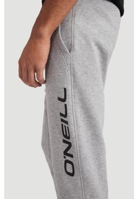 Gray sweatpants with side pockets, featuring a prominent black "O'Neill" logo vertically along the left leg. Made of soft, textured fabric.
