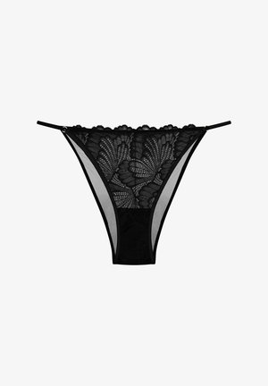 Schwarzer Spitzen-Damenstring mit Blumenmuster, durchsichtigen Mesh-Seitenpaneelen, gewellten Kanten und elastischen Trägern mit goldenen Hardware-Akzenten.