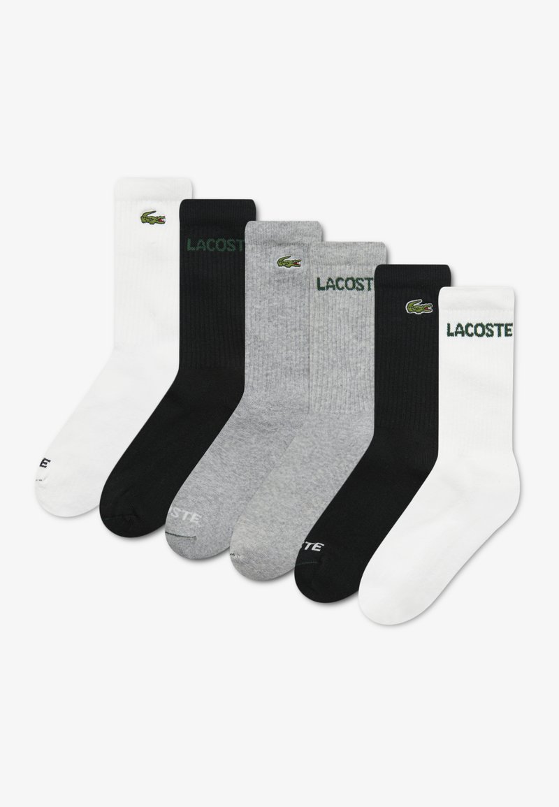 Pack of six socks in various colors: white, black, gray. Made of cotton with ribbed texture. Features embroidered Lacoste logo on each.