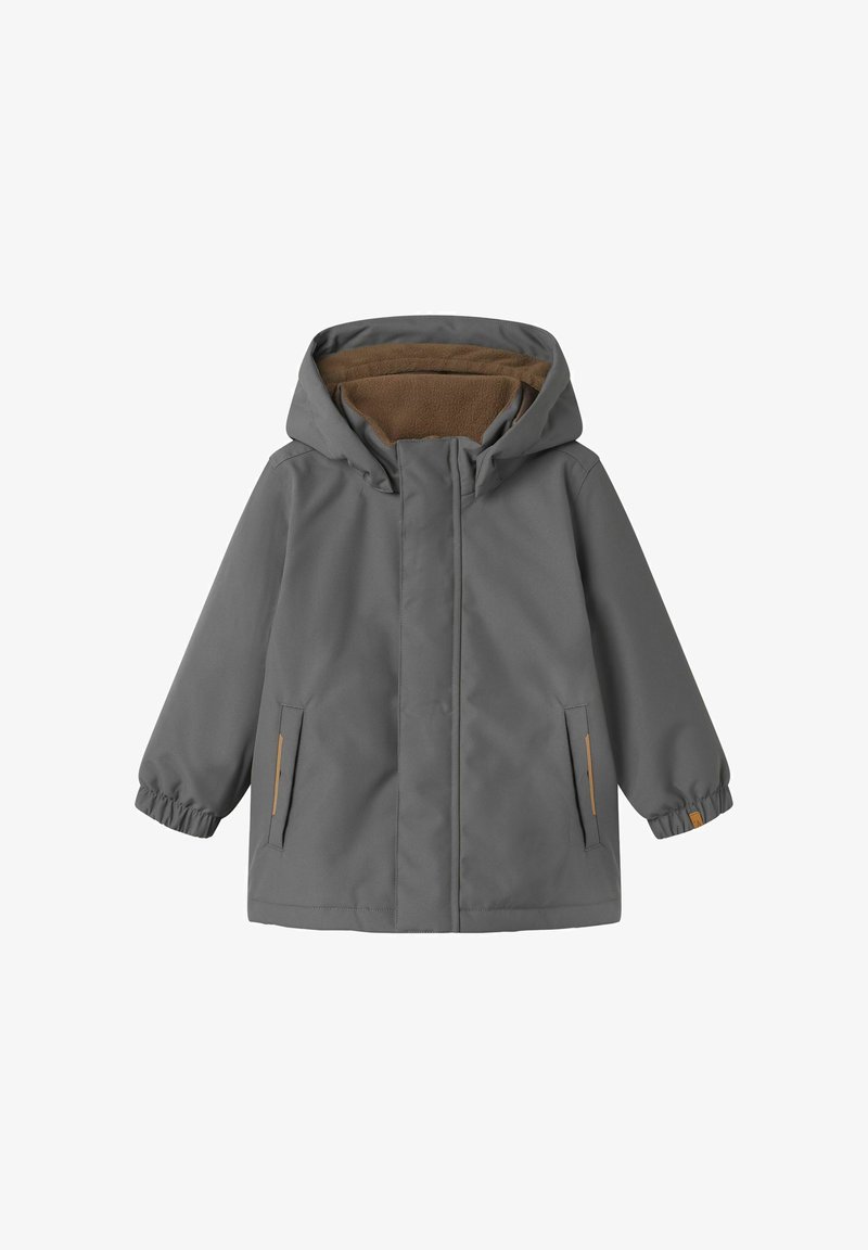 Pilkas neperšlampamas švarkas su rudos spalvos fliso pamušalu ant kapišono, elastinėmis rankogaliais ir dviem šoninėmis kišenėmis. Ypatybės: užtrauktukas priekyje su lygiu paviršiumi.