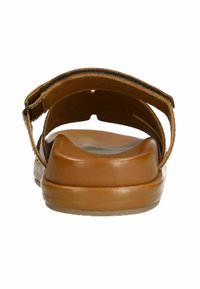 Brown leather sandal with a wide strap, adjustable buckle, and cushioned sole. Flat design with a smooth texture and sturdy construction.