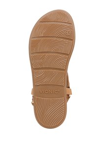 Tan rubber sandal sole with detailed traction pattern. Features grooves for grip, marked with "VIONIC," and CE certification.