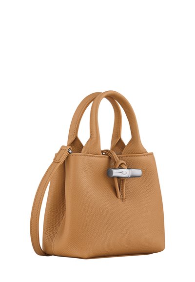 Tan leather handbag with a textured finish, featuring two short handles and a detachable shoulder strap. Silver hardware accent at the front.