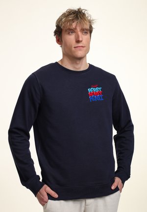 Navy blue cotton sweatshirt with long sleeves, ribbed cuffs, and crew neck. Features colorful "Pepsi" logo in bold text on the chest.