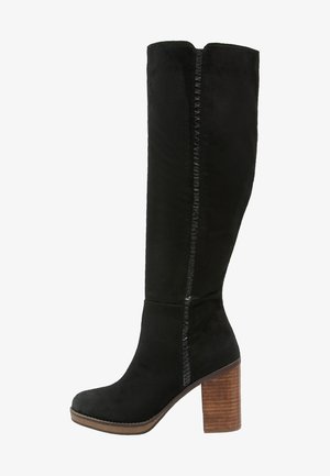 Black suede knee-high boot with a textured side seam, chunky wooden heel, and a rounded toe. Smooth surface and clean lines.
