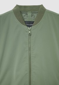 Olive green bomber jacket with a ribbed collar, full front zipper, and logo label. Smooth fabric with a sleek, minimalist design.