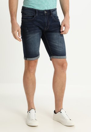 Marineblaue Denim-Shorts mit umgeschlagenen Säumen, die ein klassisches Fünf-Taschen-Design, dezente Used-Effekte und einen Knopfverschluss aufweisen.