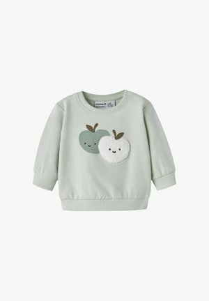 Sweat-shirt bébé manches longues vert clair avec deux pommes souriantes sur le devant, une blanche texturée et une verte lisse.