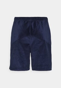 Mörkblå kordshorts med elastisk midja och kontrasterande ribbad textur på framsidan och övre sektioner.