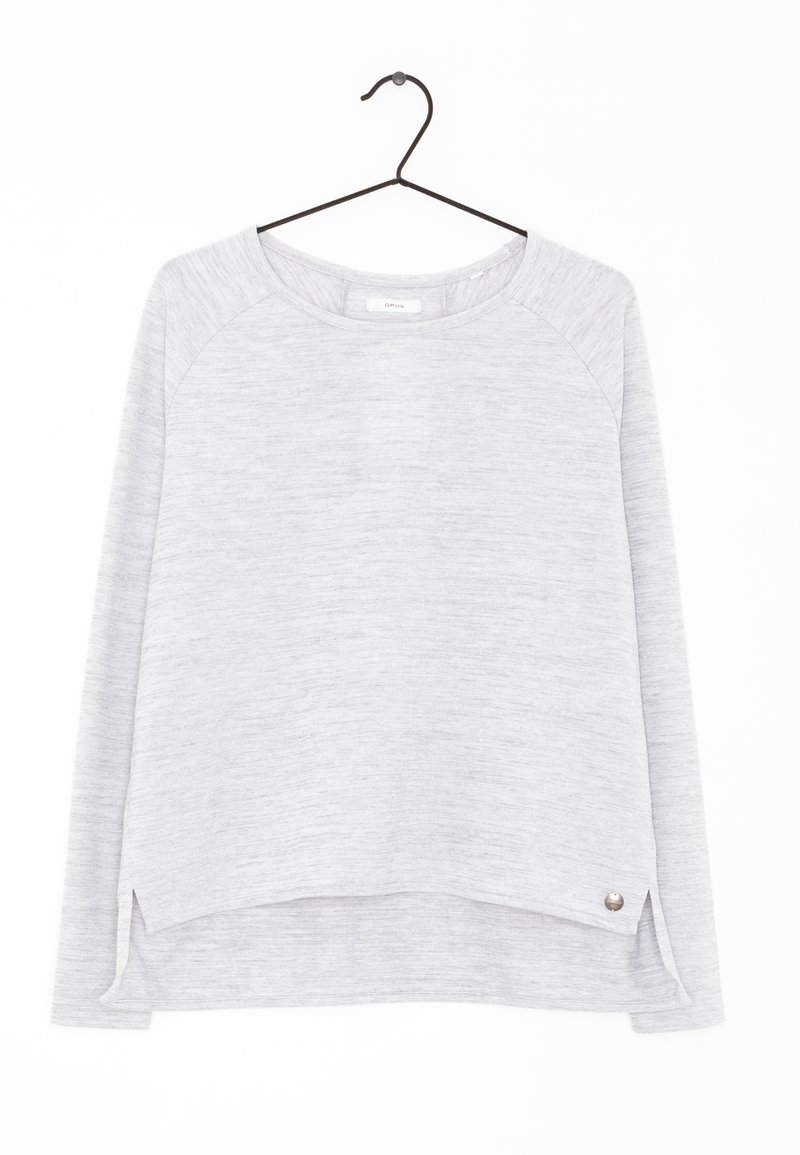 Ljusgrå långärmad tröja med rundad nederkant, raglanärmar, sidoflikar och en metallisk detalj vid fållen.