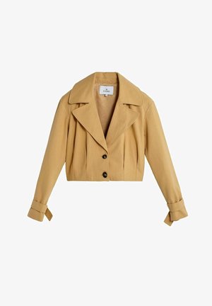 Cropped mustard yellow jacket with a notched collar, front pleats, and two black buttons. Features rolled cuffs and a soft texture.