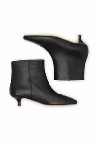 Juodos odinės aulinės batai su smailia nosimi ir žemu kūgio formos kulnu. Lygus paviršius su siūlės detalėmis gale. Paprastas dizainas.