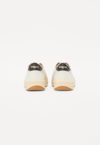 Hvite lær sneakers med beige gummisåler, med marineblå detaljer og "Blauer"-logoen på hælen. Renslig og minimalistisk design.