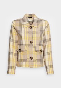 Geruite jas in beige, geel en zwart, met een kraag, grote bruine knopen en twee voorzakken. Geweven stof met een gestructureerd ontwerp.