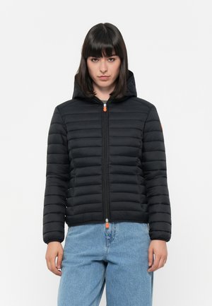 Zwarte gewatteerde jas met capuchon, gestikt ontwerp, vooraan met een rits en een oranje ritslip. Beschikt over elastische mouwen en een slim fit.